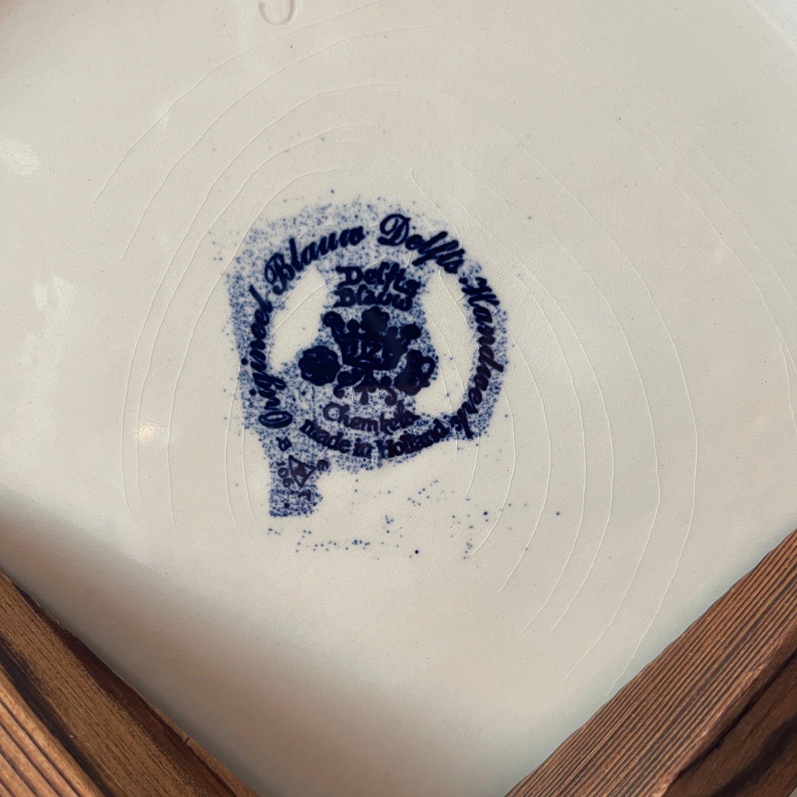 White plate with a blue floral design and text on a white background