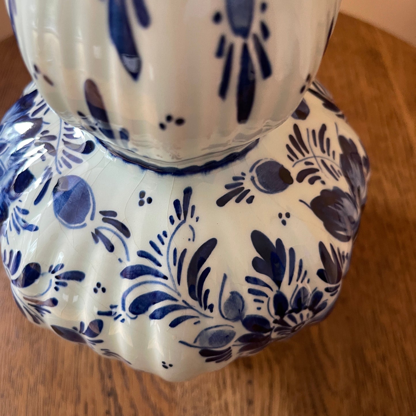 Ceramic vase with blue floral patterns on a wooden surface