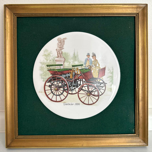 Framed artwork of a vintage carriage with people on a white background, framed in gold.