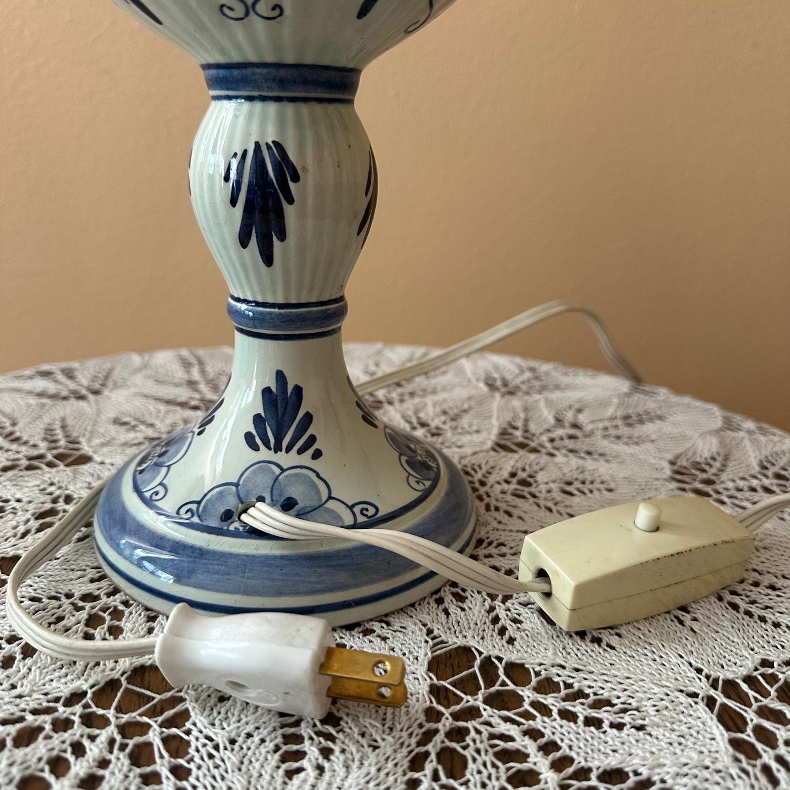 Ceramic lamp with blue decorative patterns on a lace tablecloth