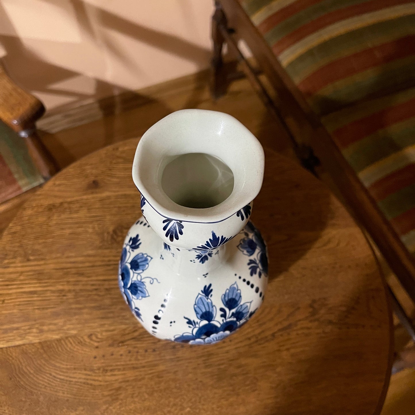White vase with blue floral patterns on a wooden table
