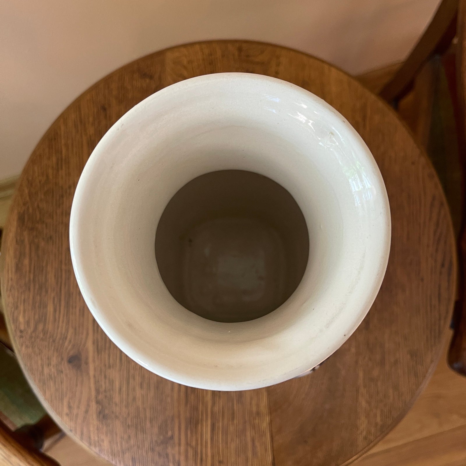 White ceramic vase on a wooden surface
