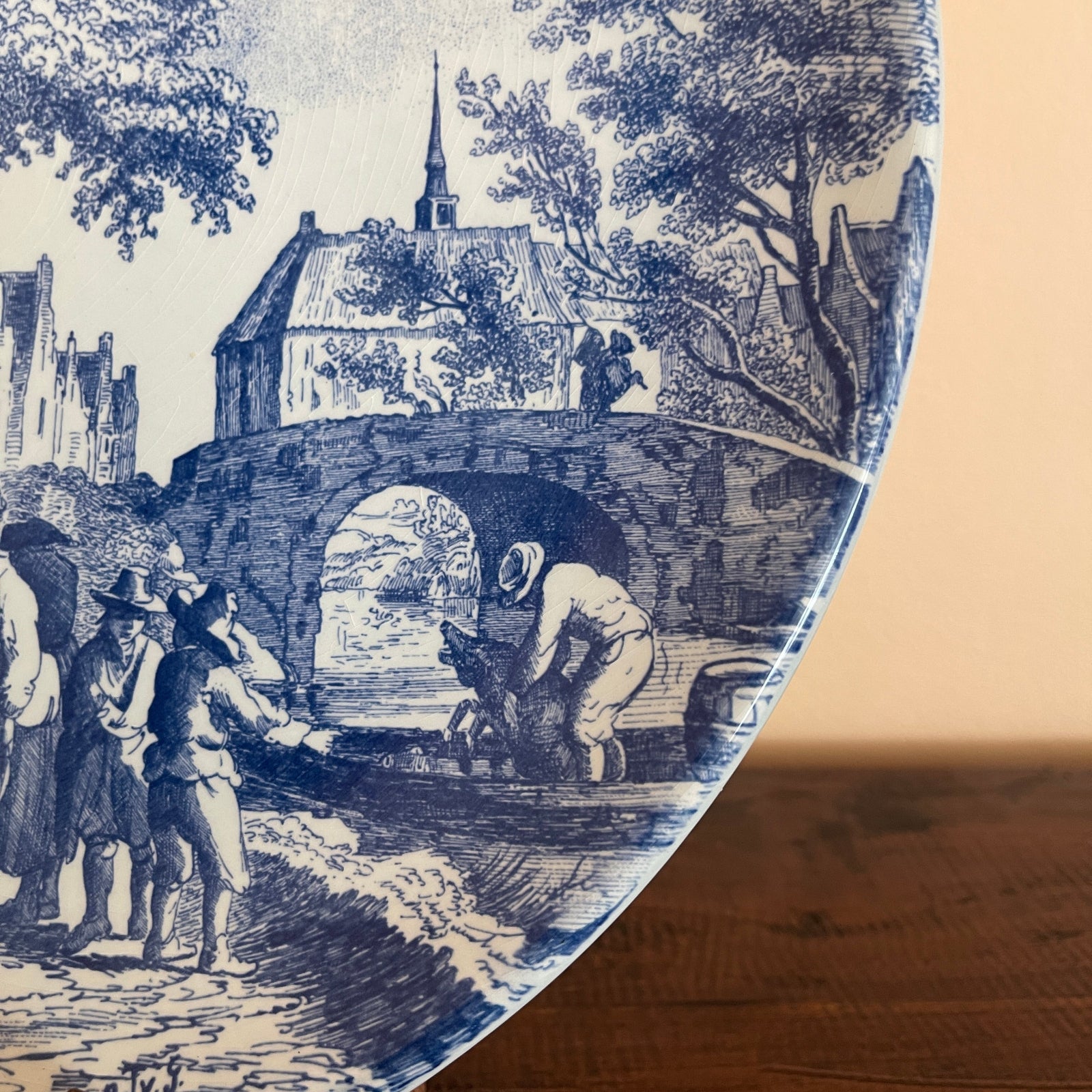 Blue and white vintage-style illustration on a ceramic plate