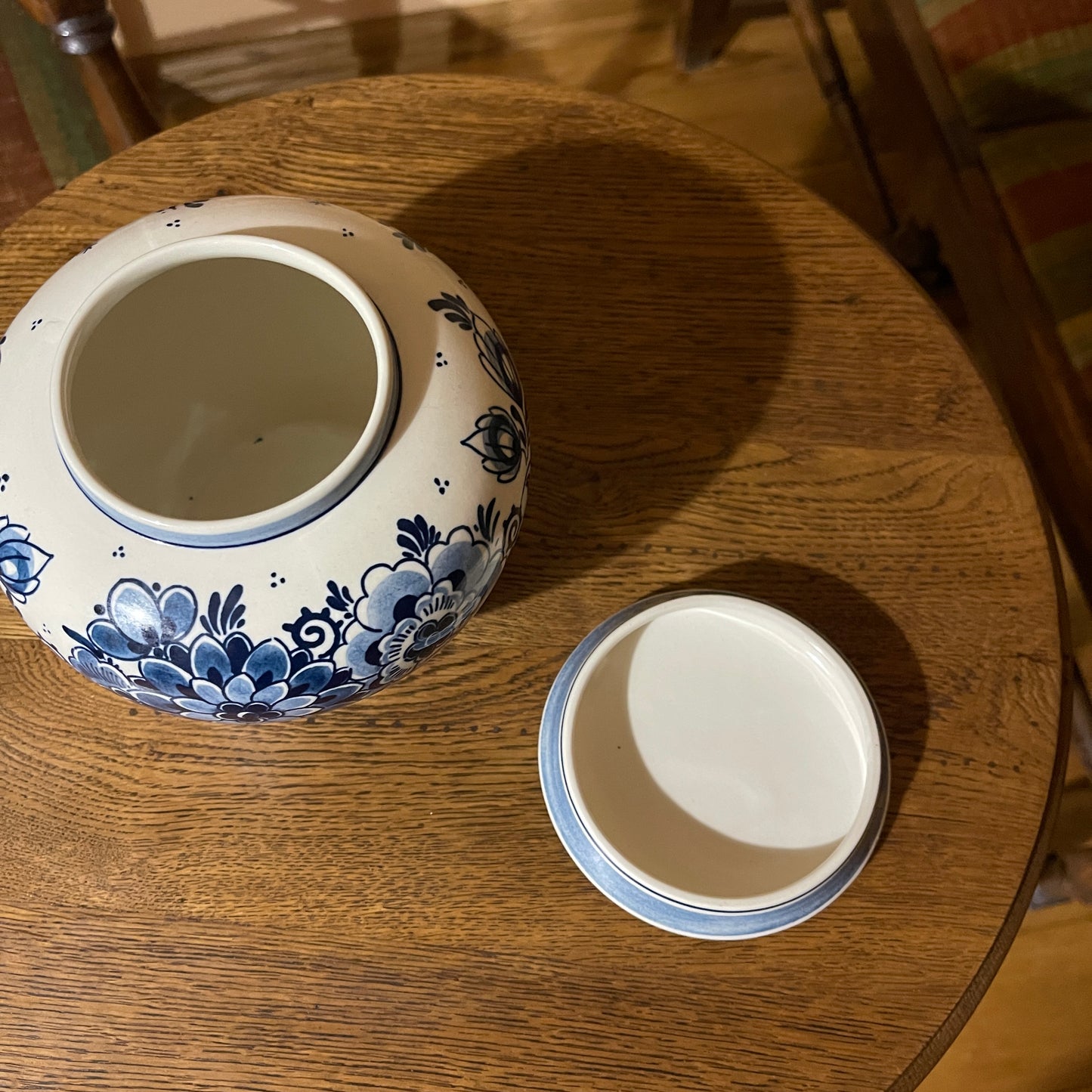Ceramic jar with blue floral patterns on a wooden surface