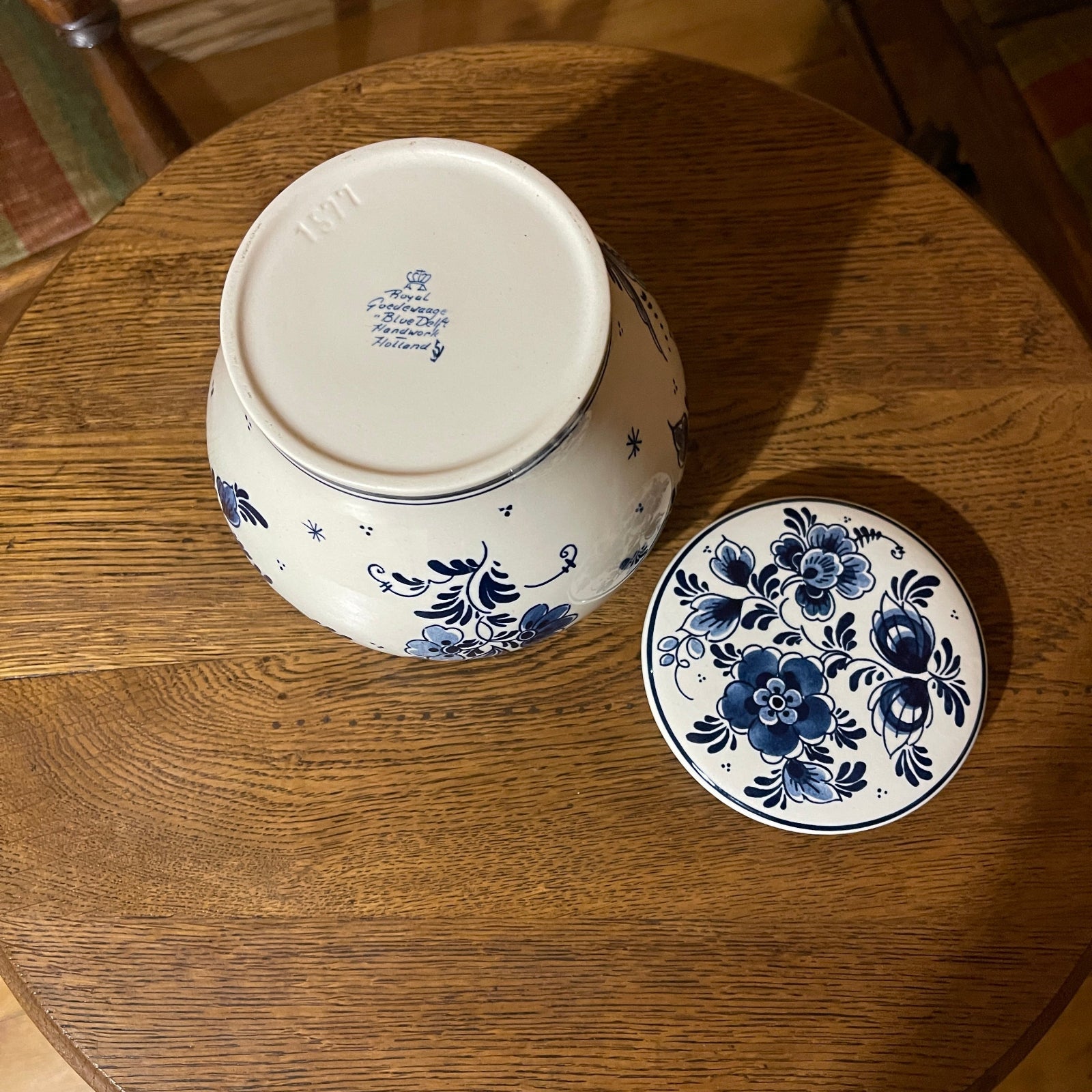 Ceramic jar with blue floral design on a wooden surface
