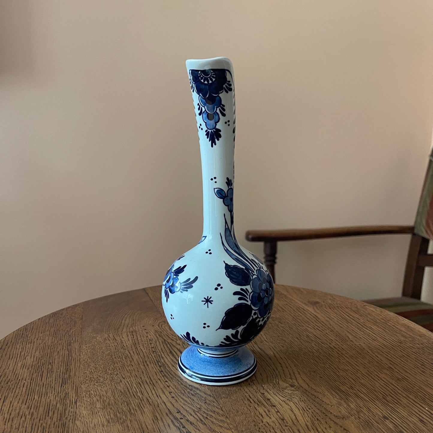 White vase with blue floral patterns on a wooden table