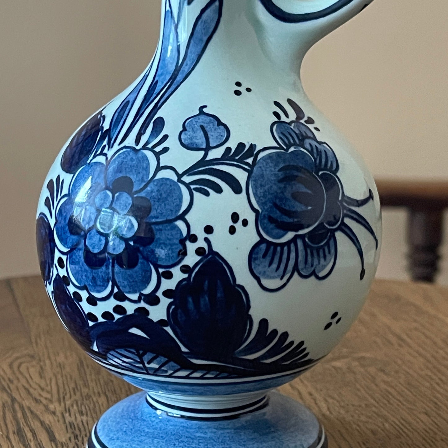 Blue and white floral-patterned vase on a wooden surface