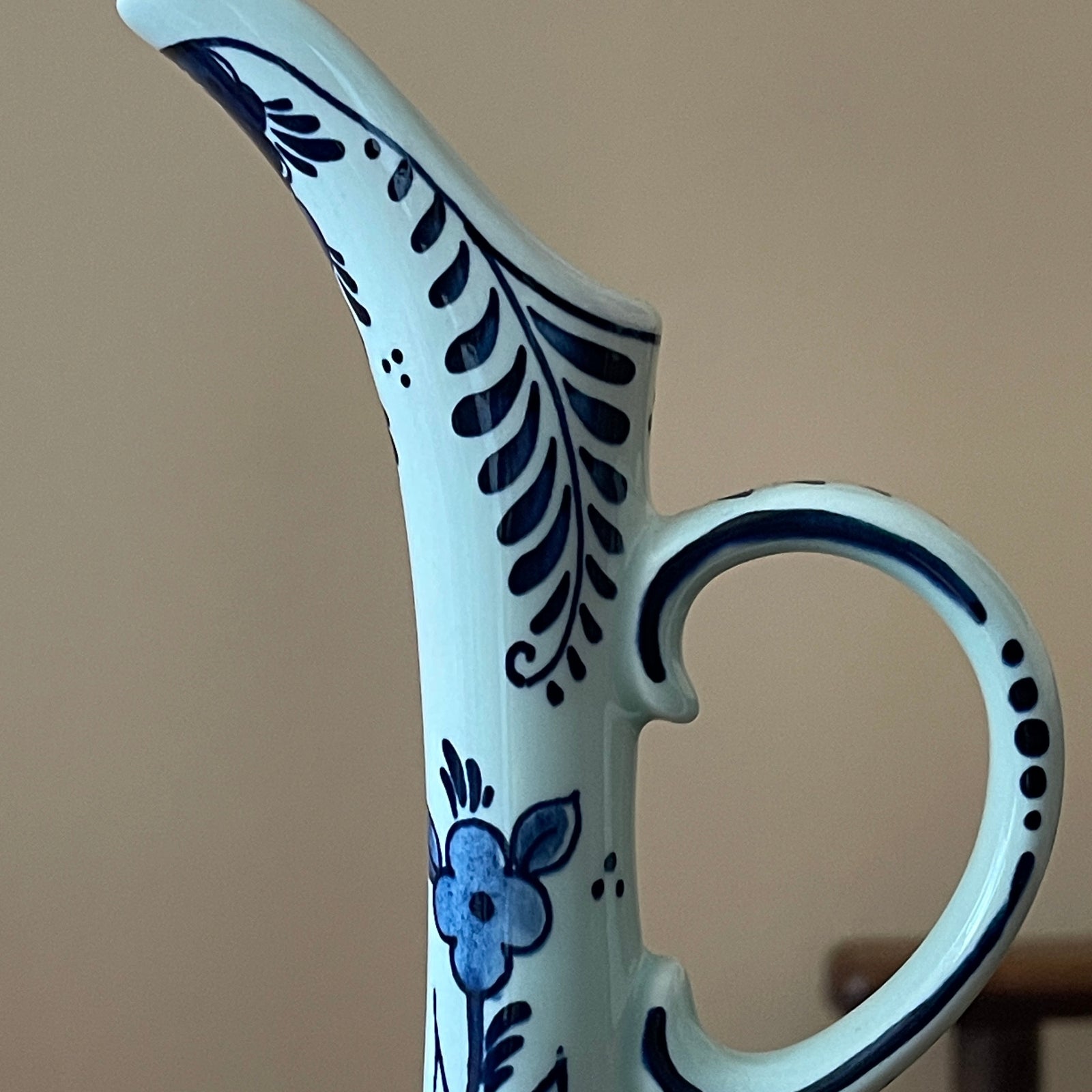 Ceramic vase with blue floral patterns on a beige background