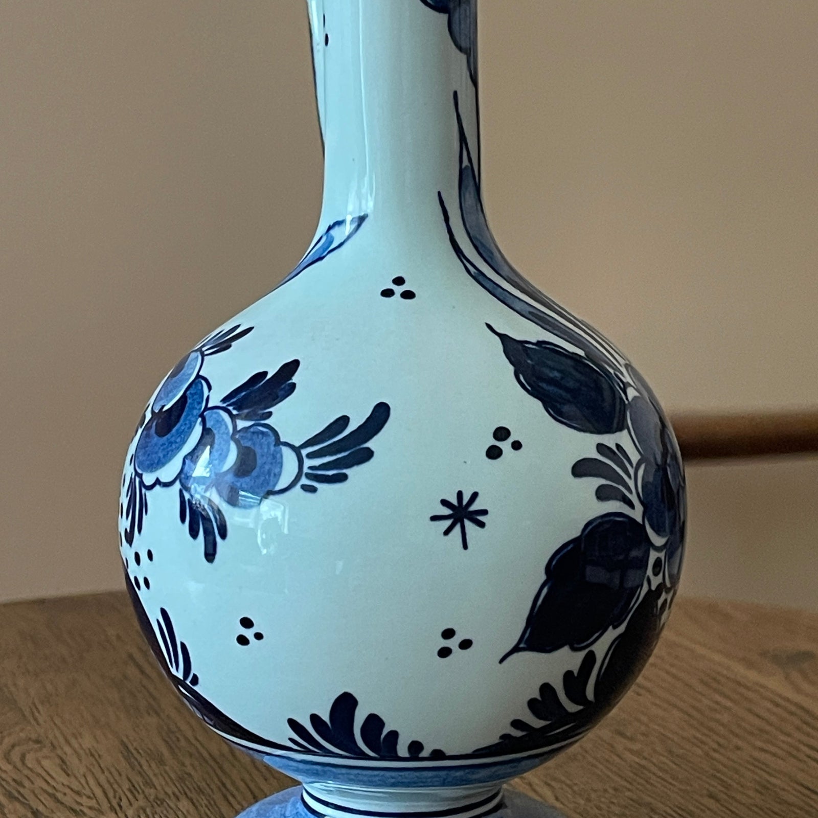 White vase with blue floral patterns on a wooden surface