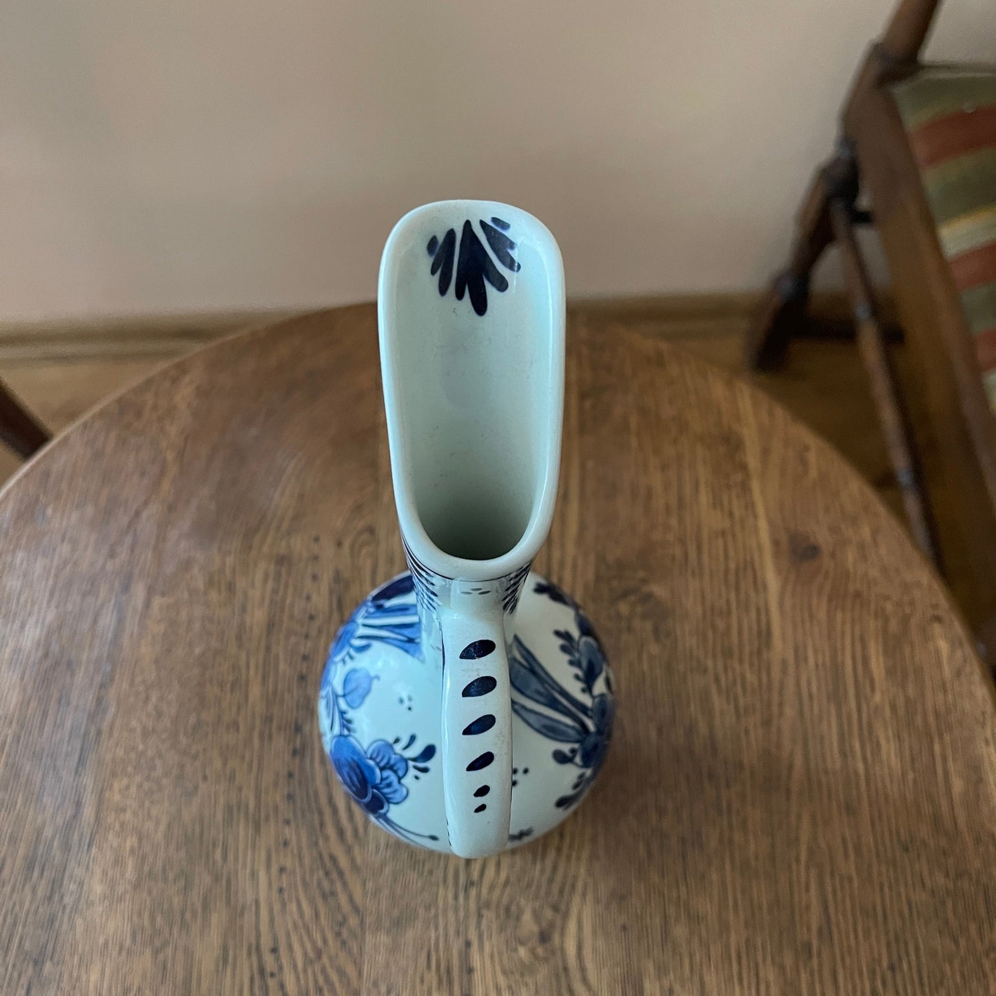 Ceramic vase with blue floral patterns on a wooden surface