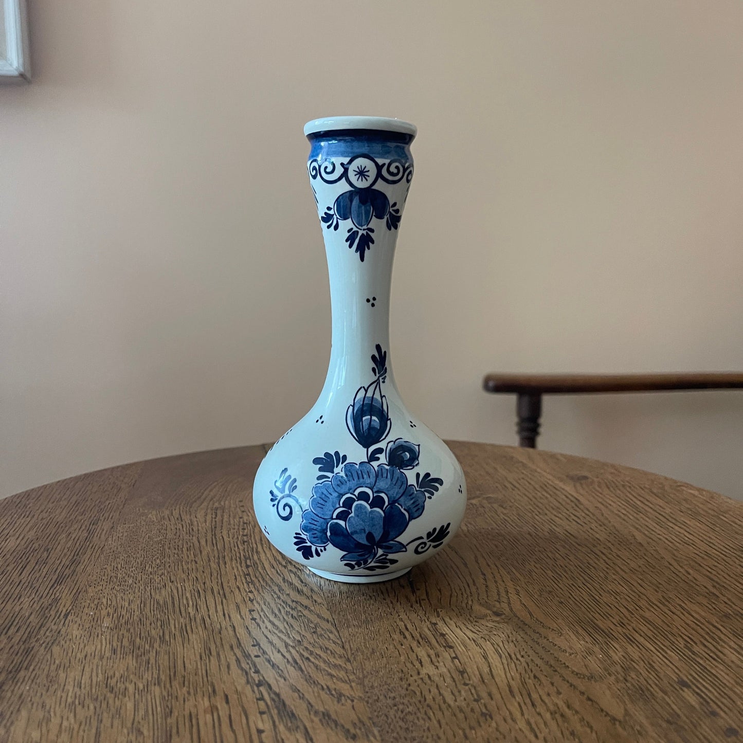 White vase with blue floral patterns on a wooden surface