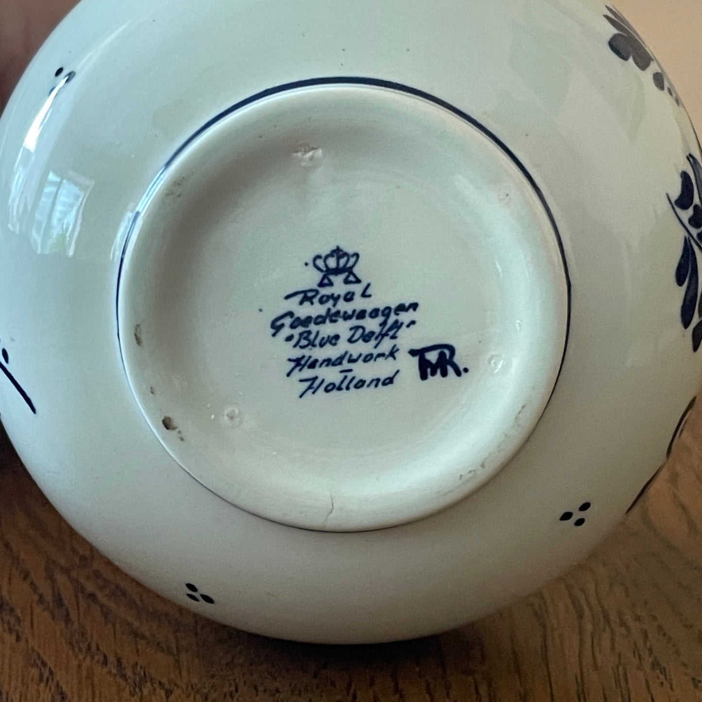 Back view of a ceramic product with 'Royal Delft' branding on a wooden surface