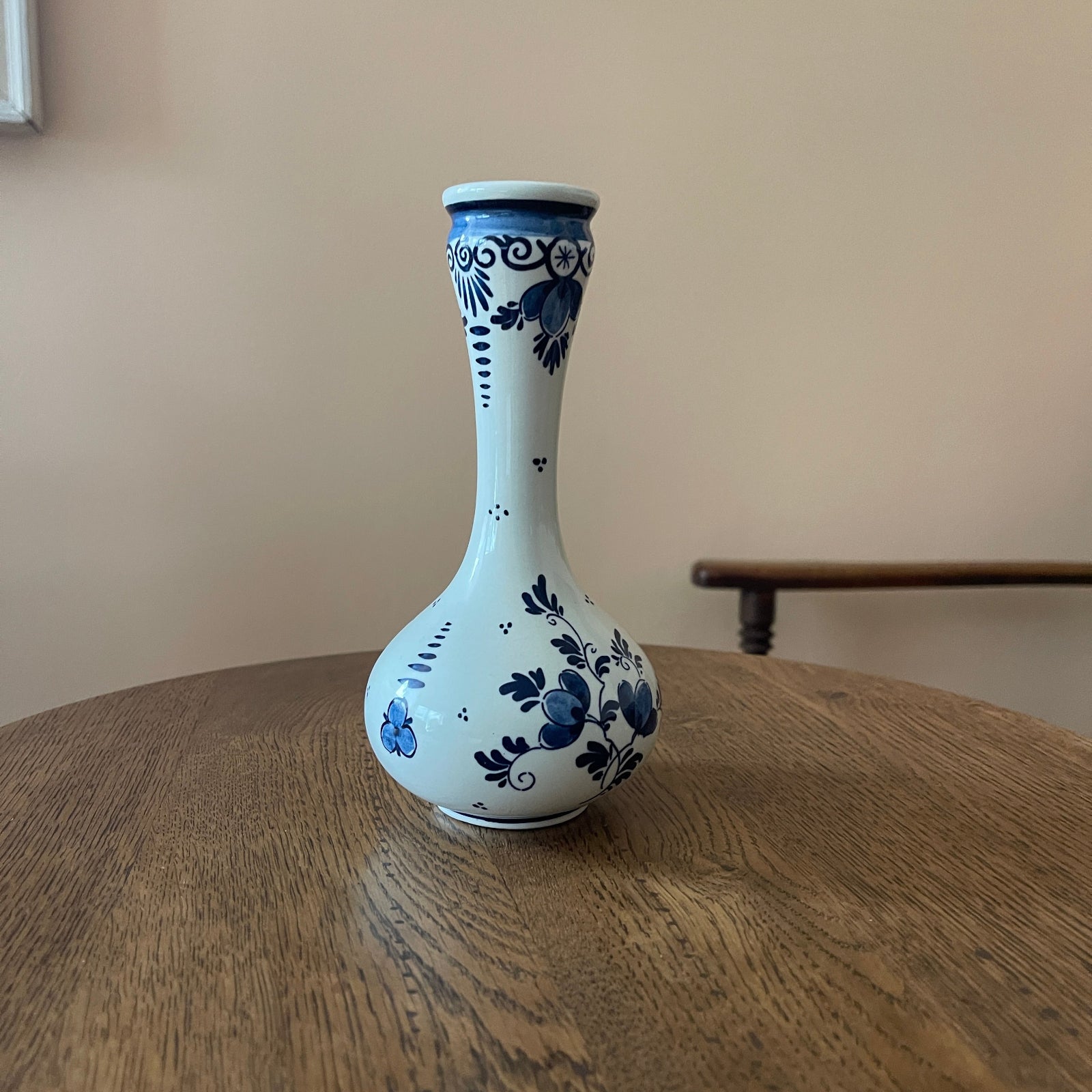 White vase with blue floral patterns on a wooden surface