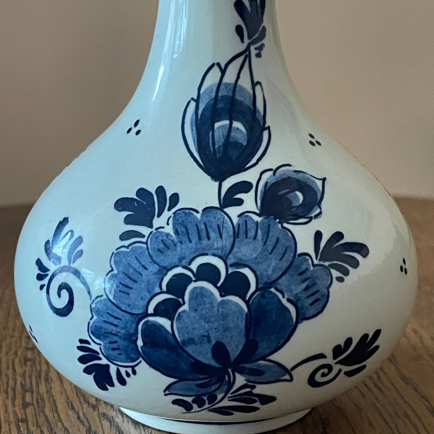 White vase with blue floral patterns on a wooden surface