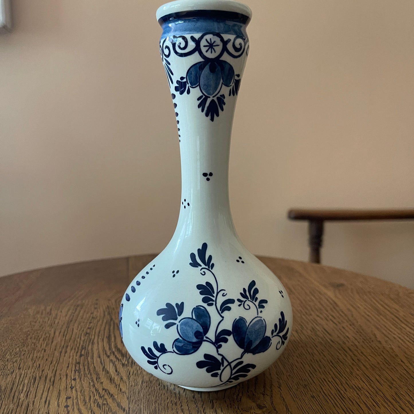 White vase with blue floral patterns on a wooden surface