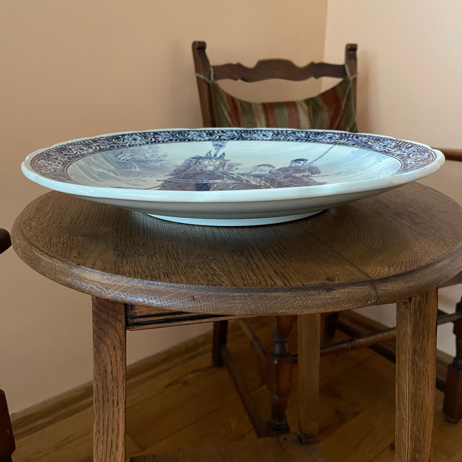 Decorative plate with blue and white design on a wooden table