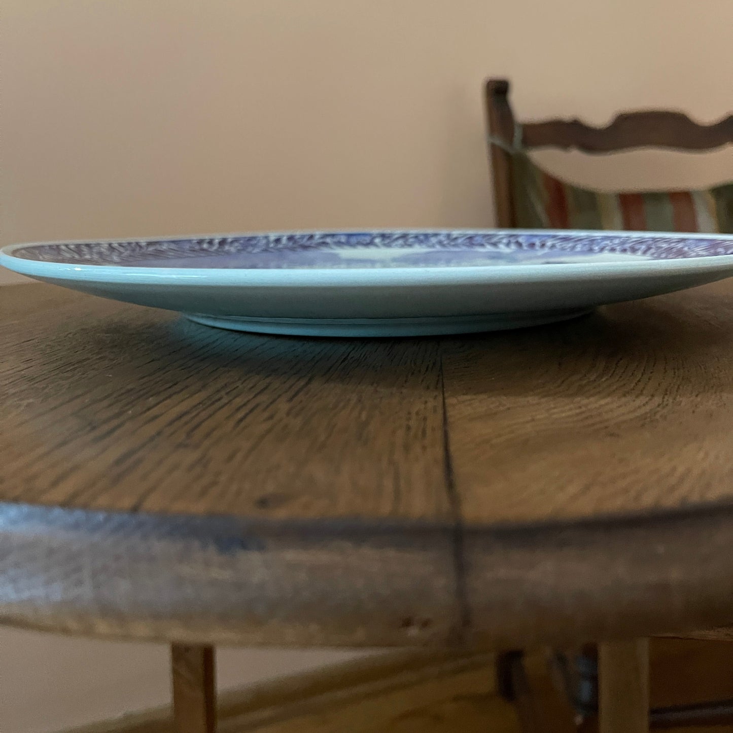 White plate with blue patterns on a wooden table