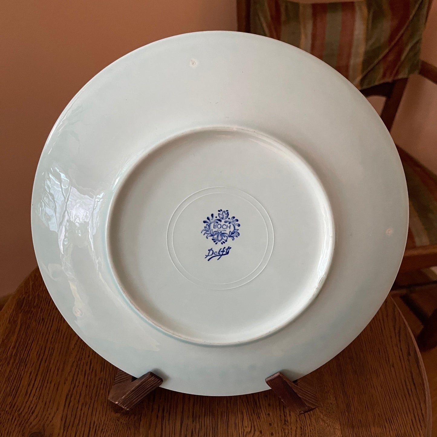 White plate with a blue logo on a wooden surface