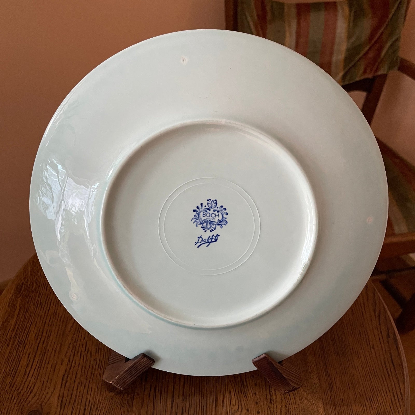 White plate with a blue logo on a wooden surface