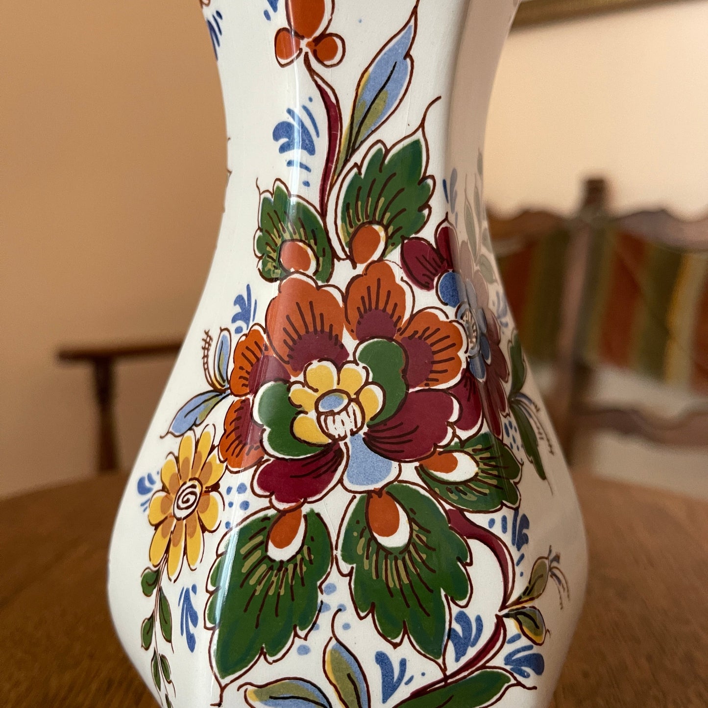 Decorative vase with floral patterns on a wooden surface