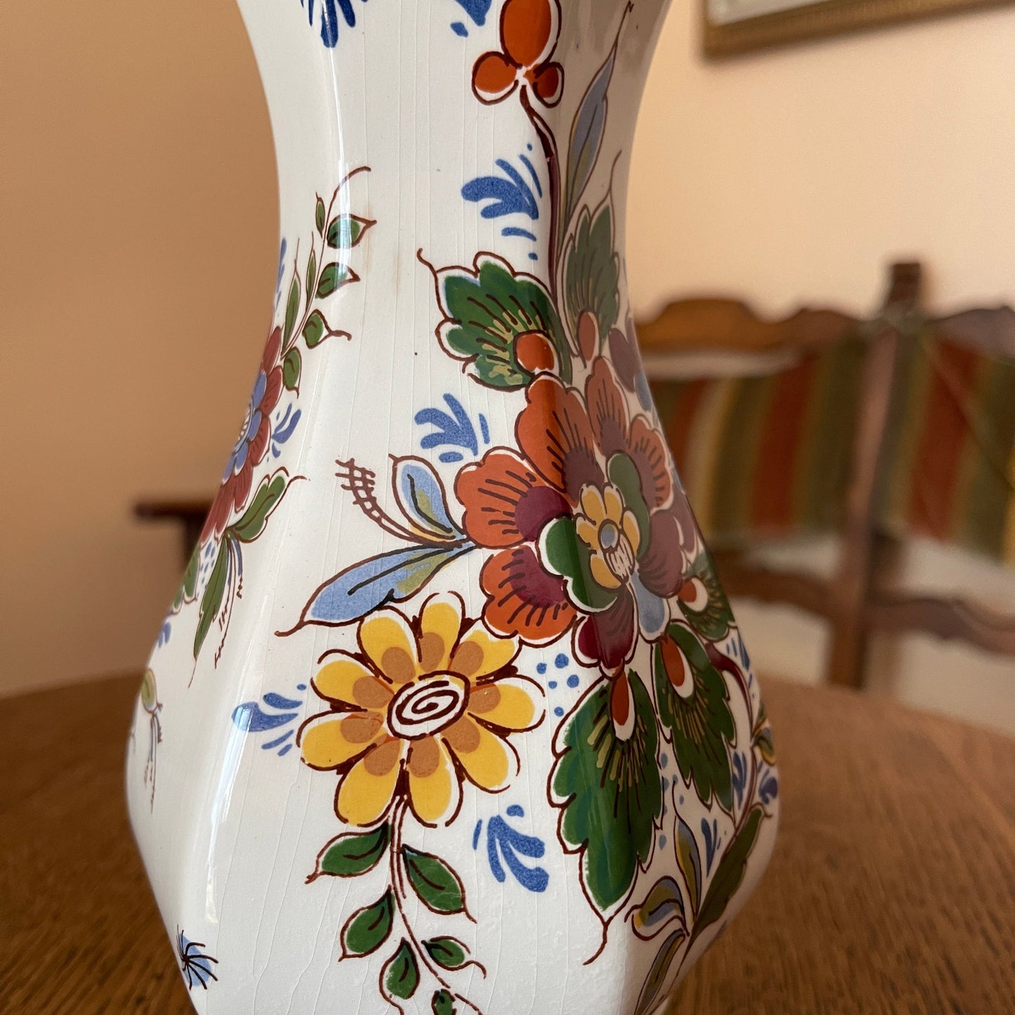 Decorative ceramic vase with floral patterns on a wooden surface