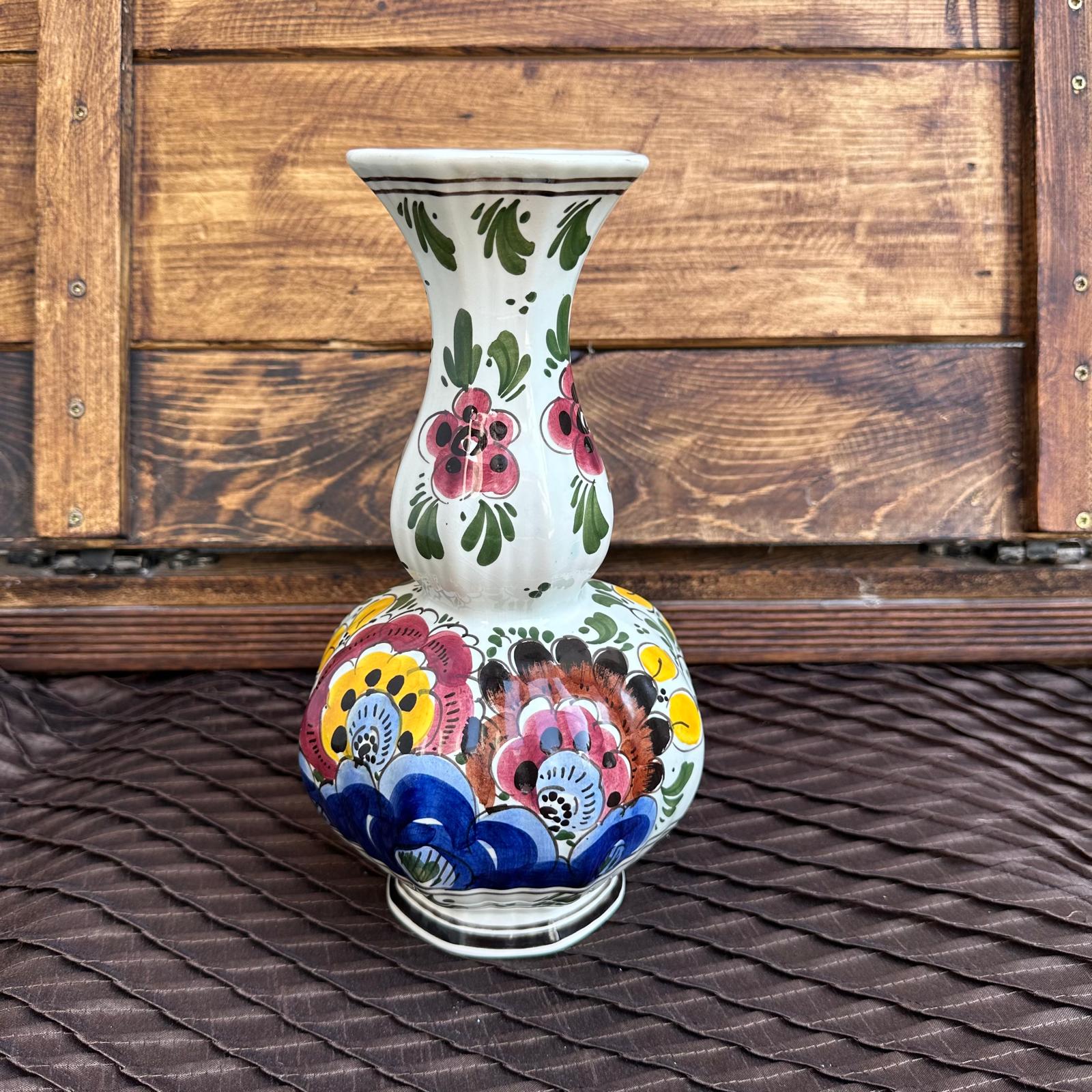 Decorative vase with floral patterns on a wooden surface