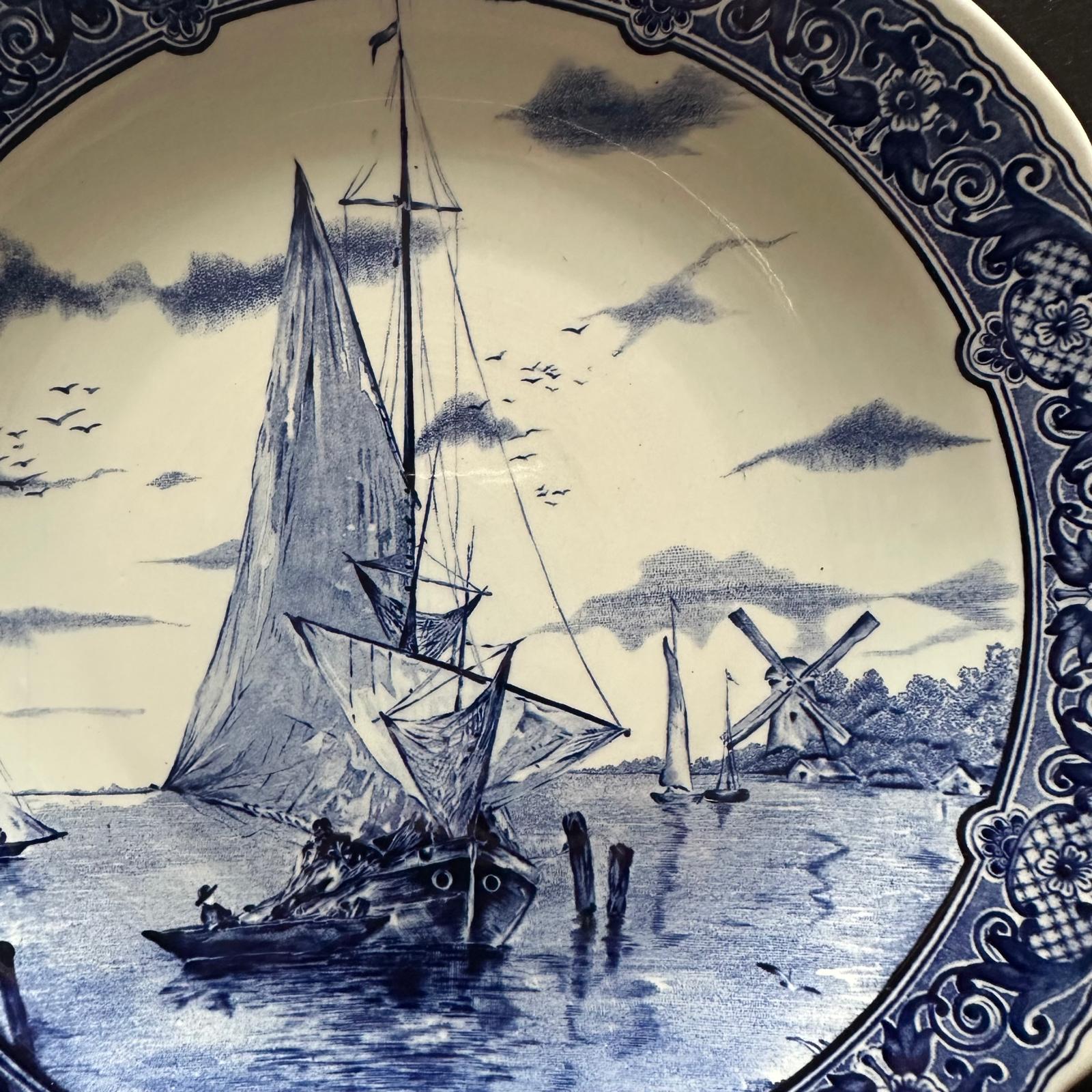 Decorative plate with blue and white ship and mill design