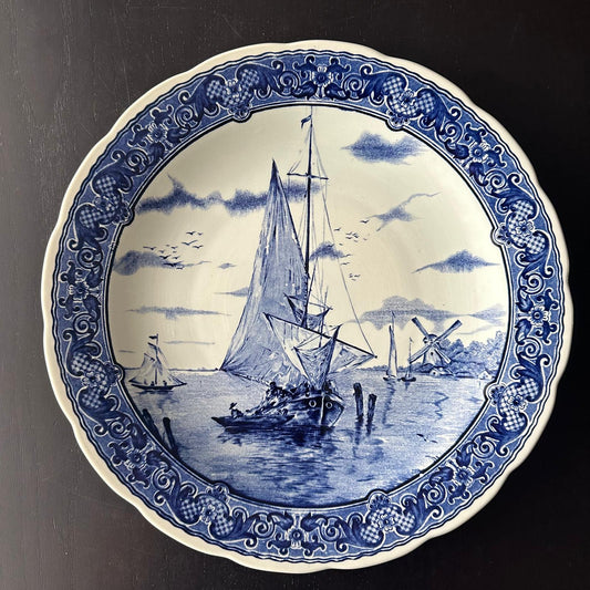 Decorative plate with blue and white nautical design featuring sailboats and windmills.