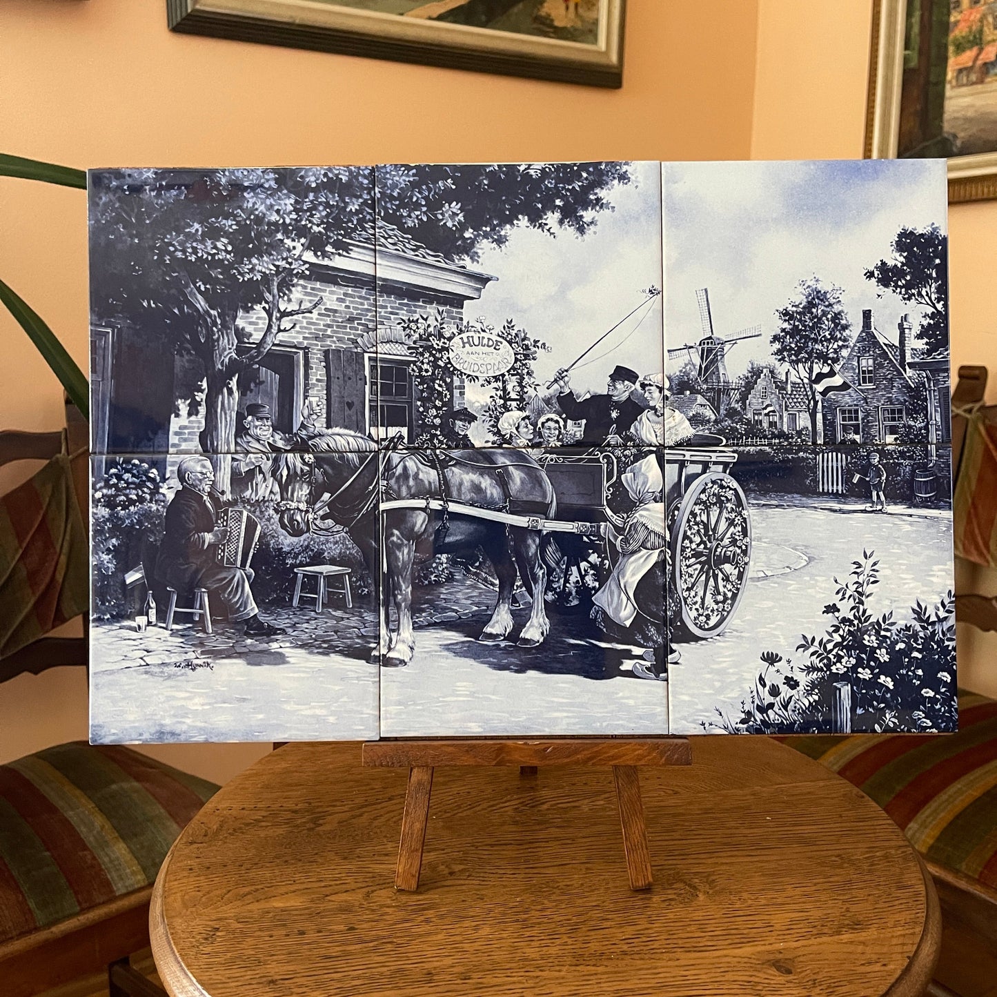 Black and white collage of a horse-drawn carriage scene on a wooden stand.