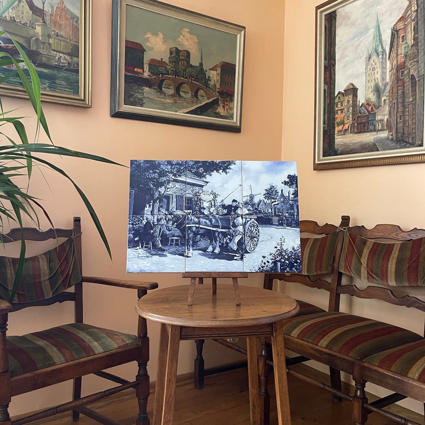 Dining room with wooden table and chairs, framed artwork on the wall.