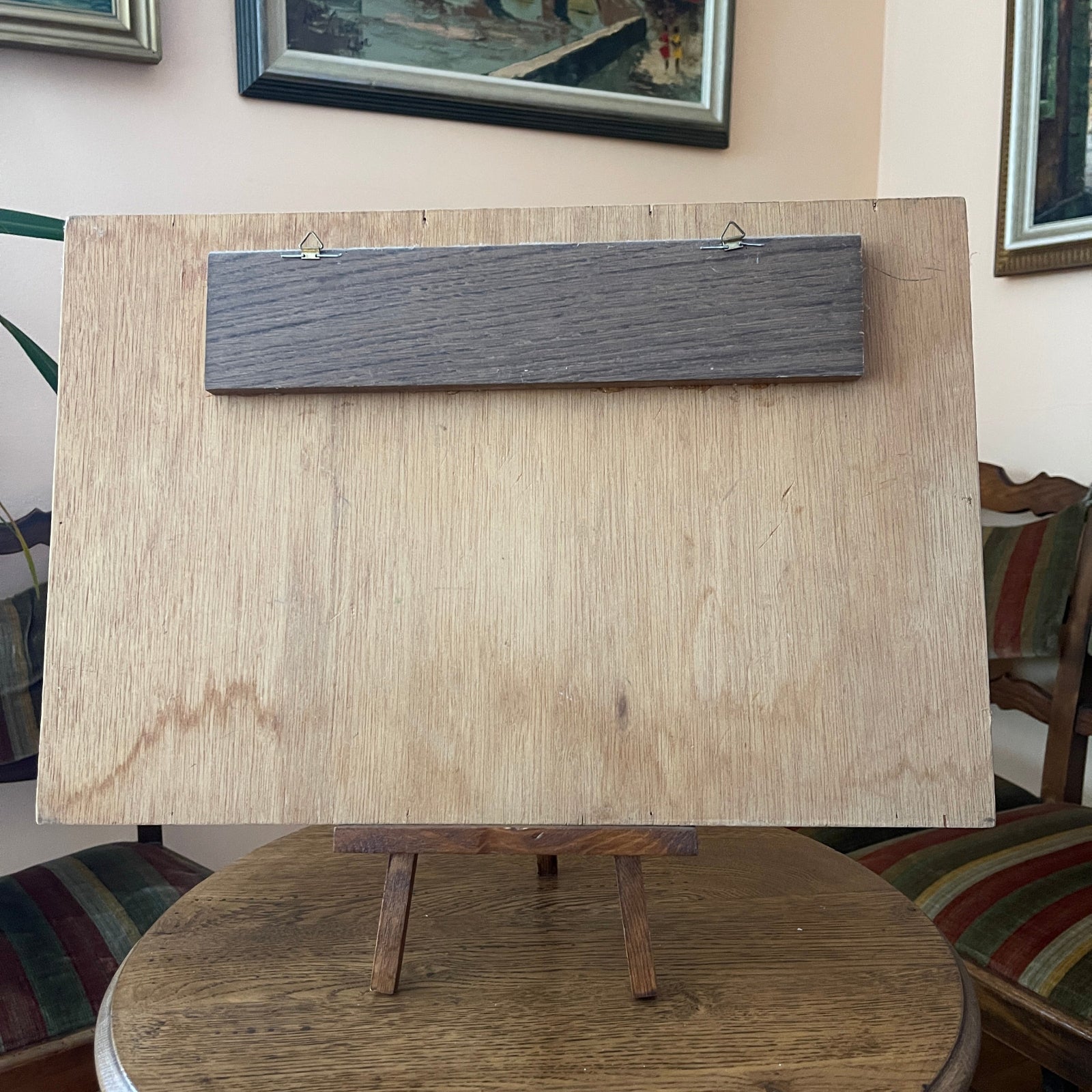 Wooden board on a stand with a plain background
