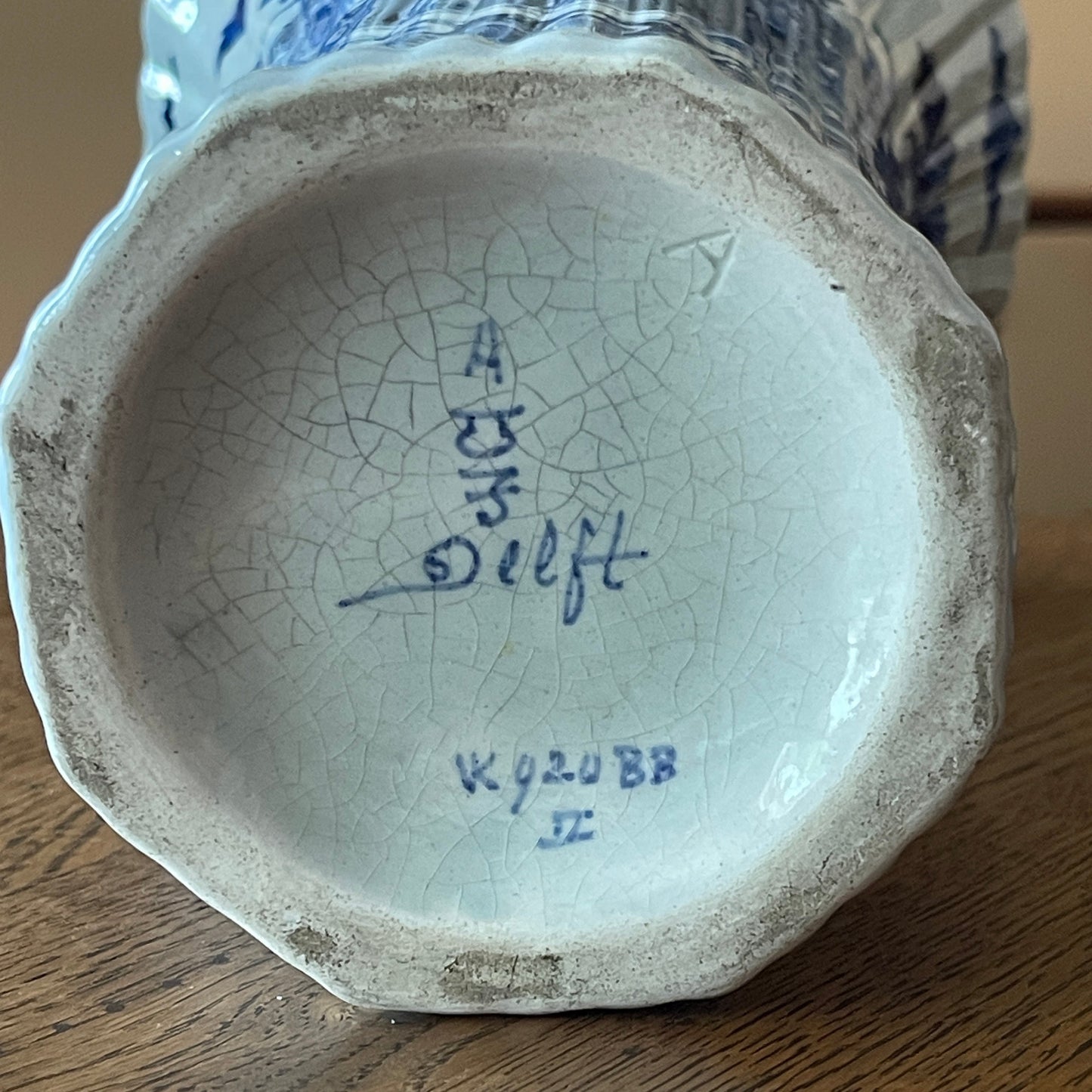 Ceramic vase with a cracked base and visible Royal Delft signature 