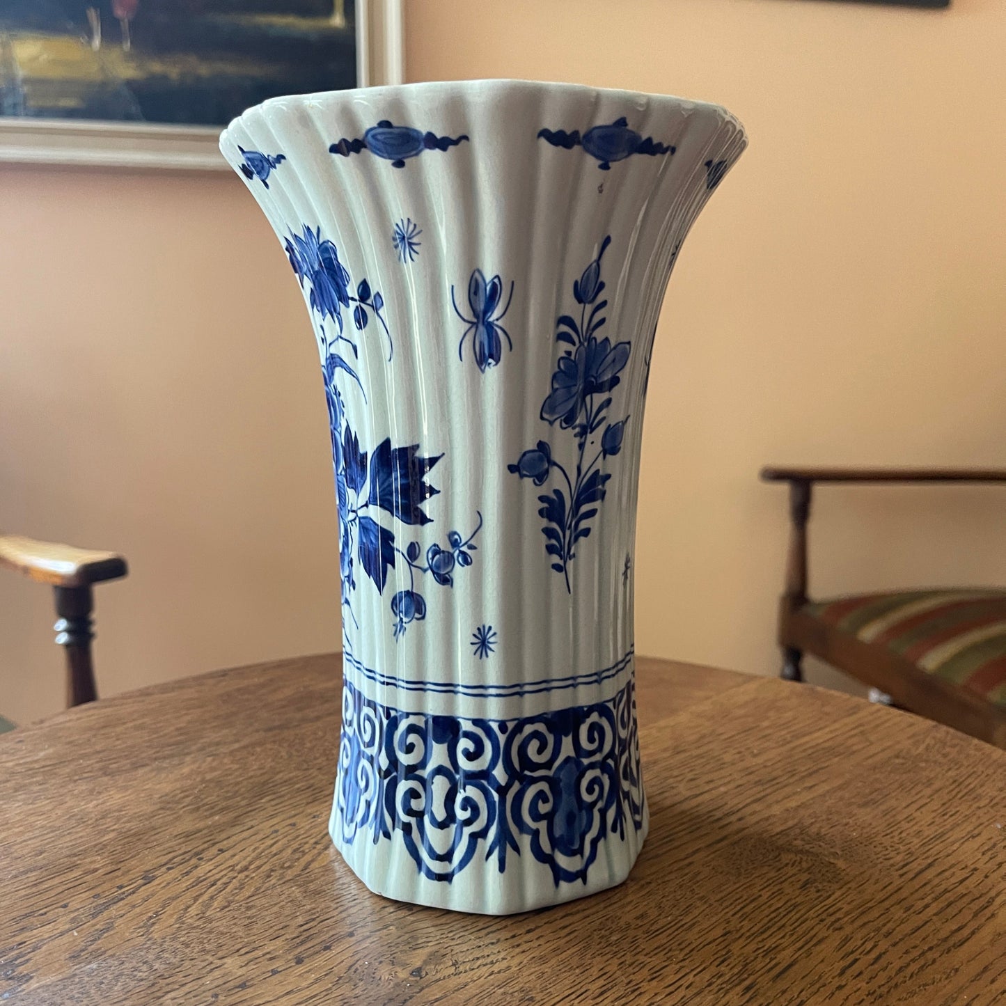 Blue and white decorative vase on a wooden table with a neutral background