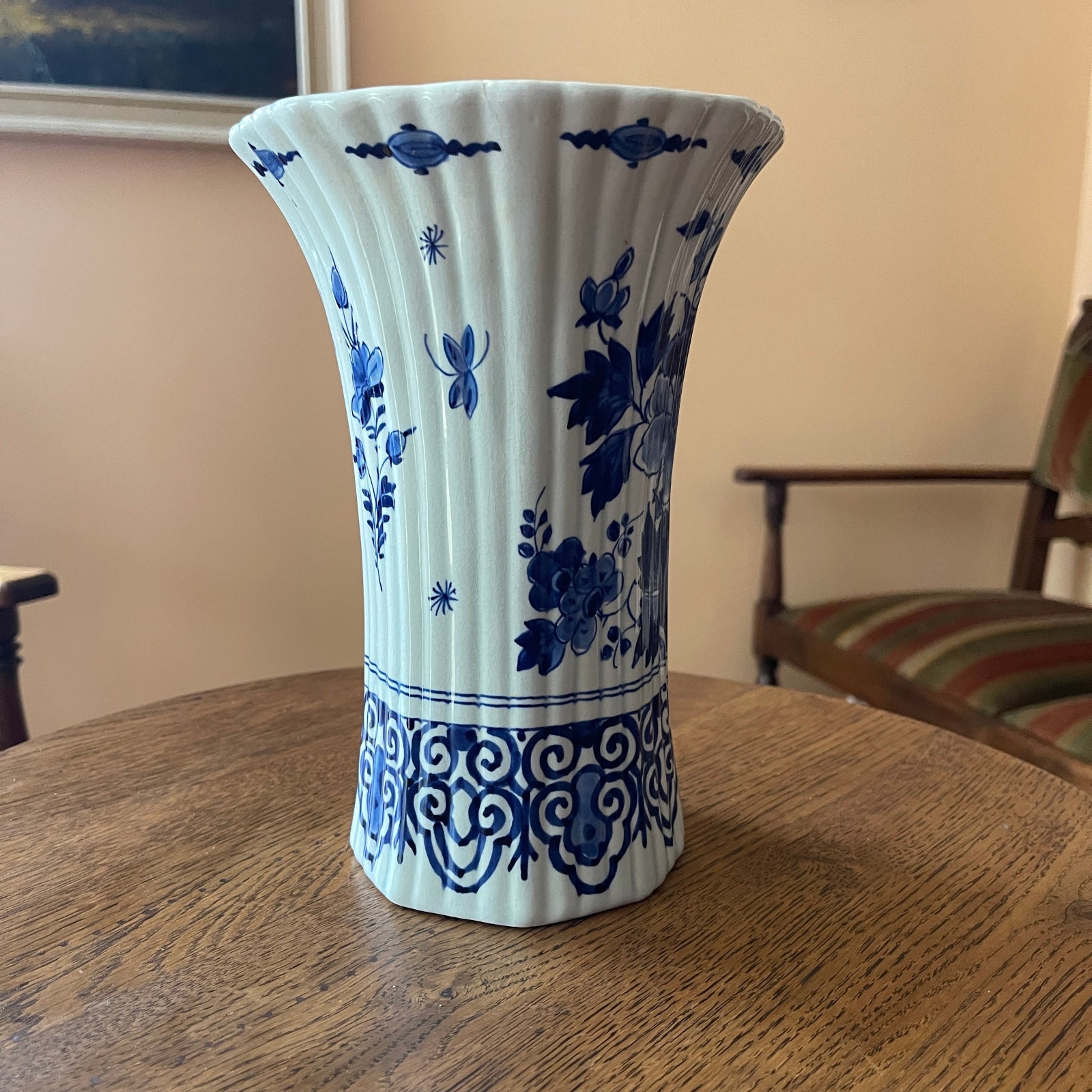 White vase with blue floral patterns on a wooden table