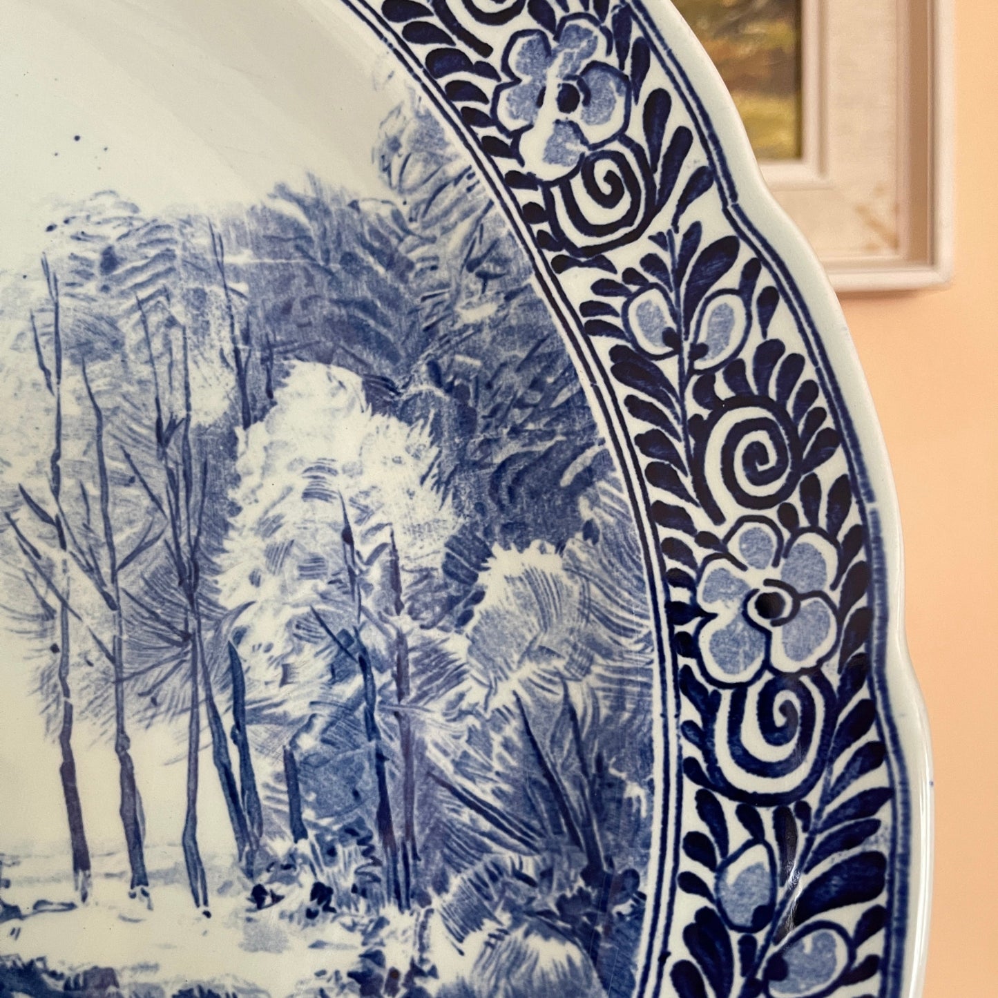 Decorative plate with blue floral pattern and winter landscape design