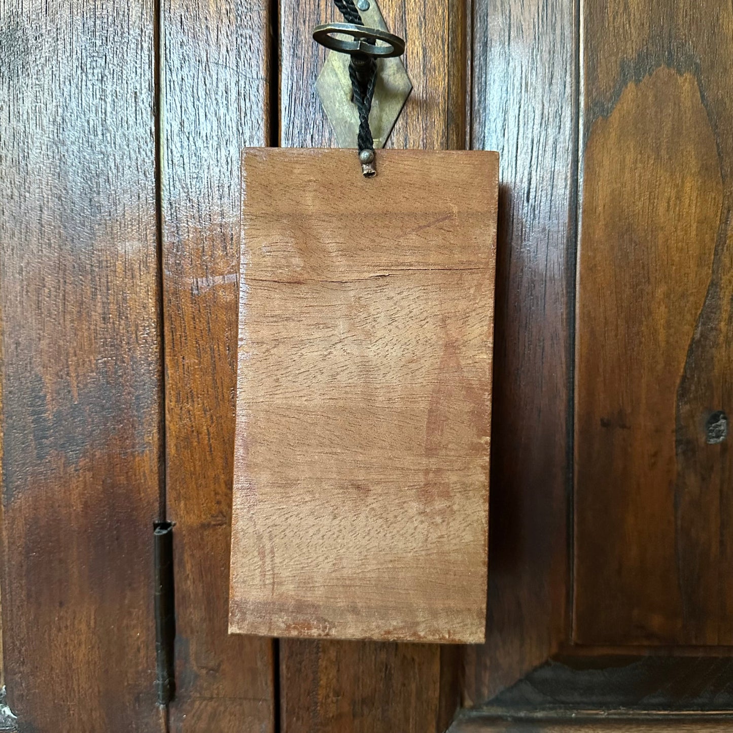Wooden sign hanging on a wooden panel wall