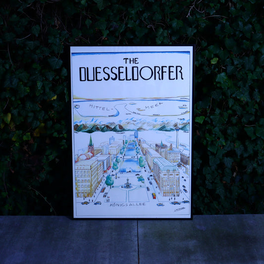 A large framed poster depicting a cityscape with the title 'The Duesseldorfer' signed by J.W.