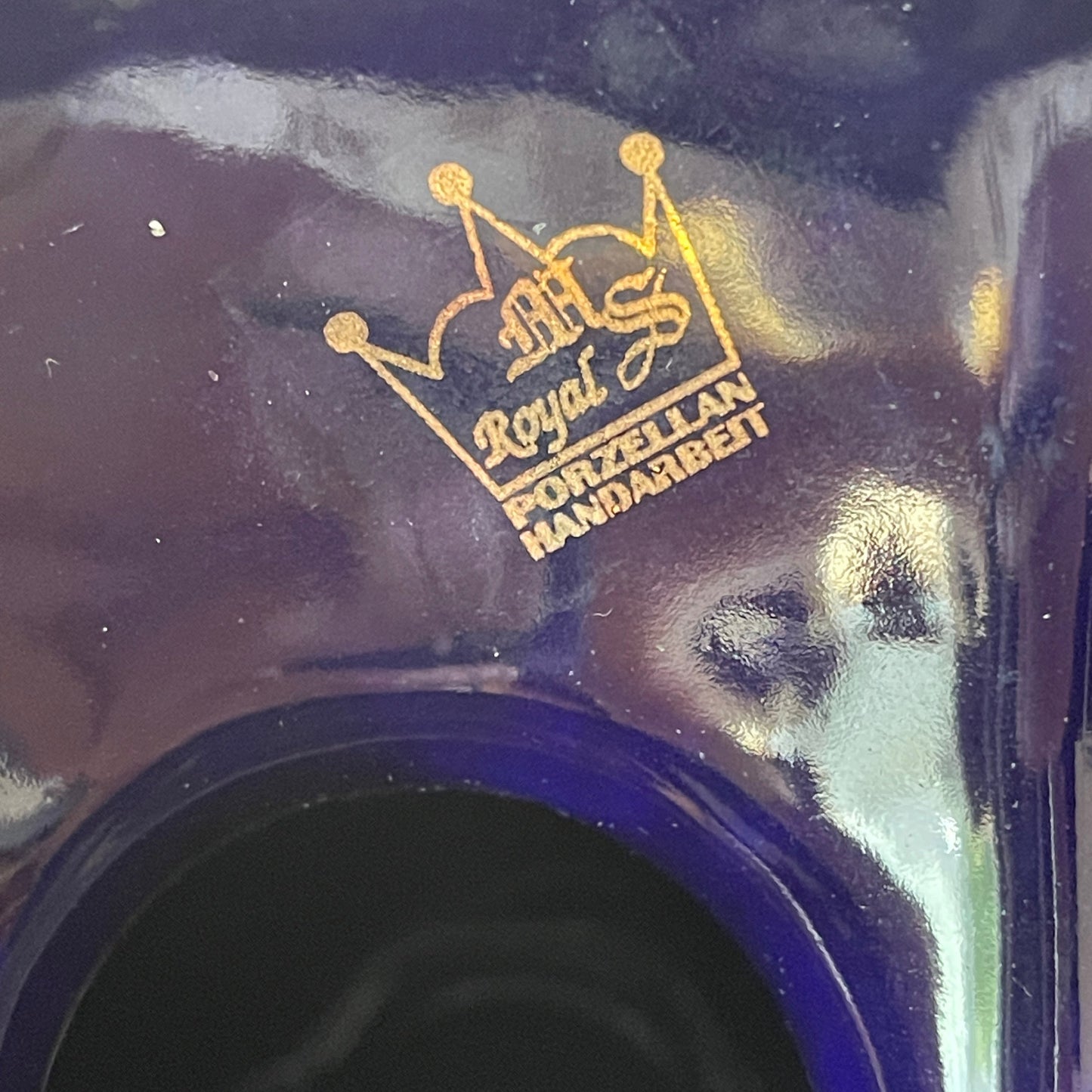 Close-up of a gold logo on a blue background