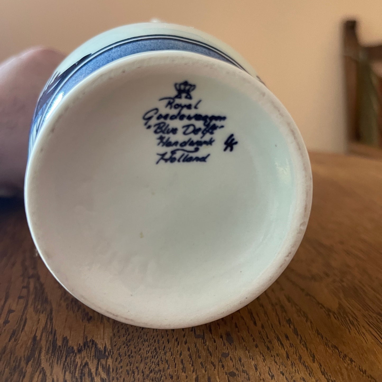 Ceramic bowl with 'Royal Delft' branding on a wooden surface