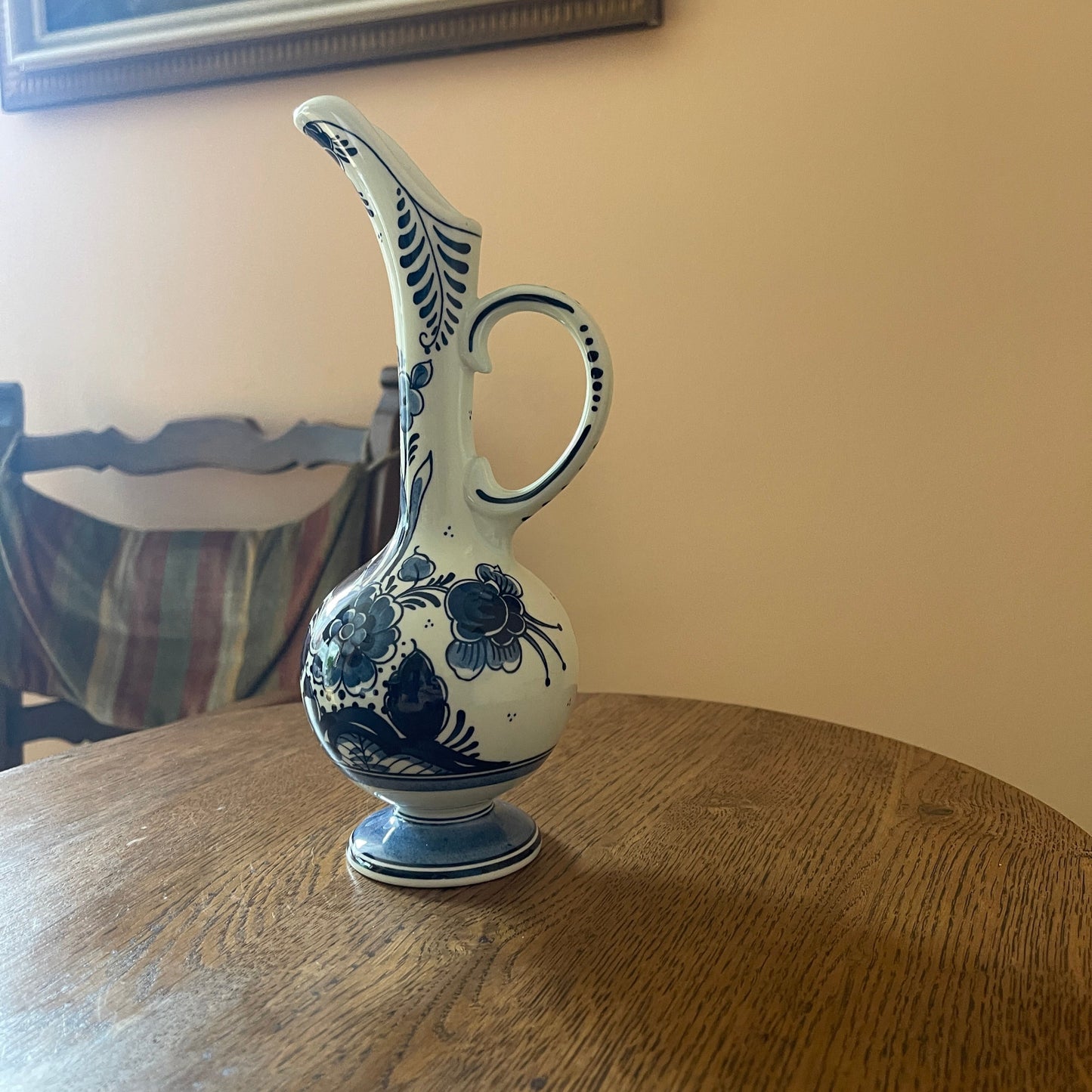 Ceramic pitcher with blue floral patterns on a wooden table