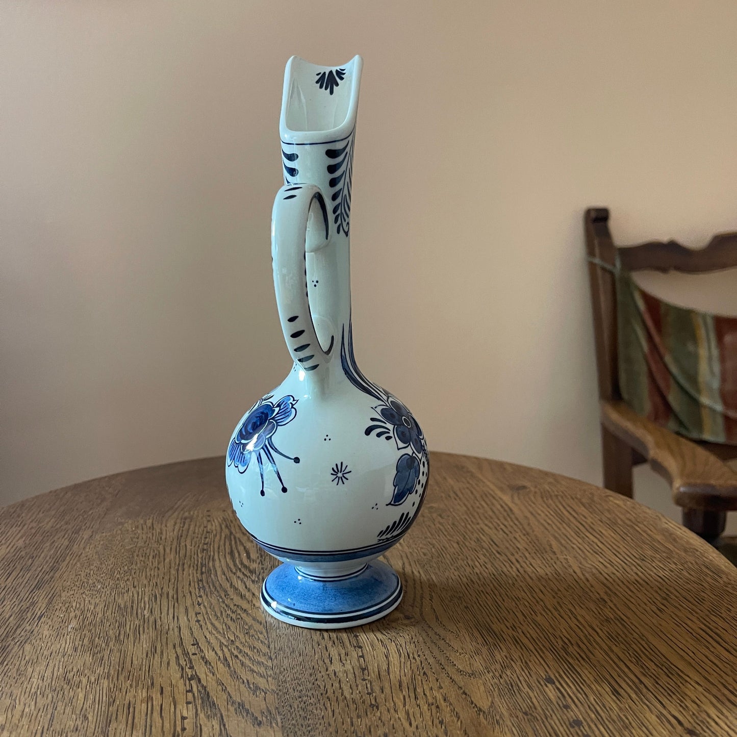 White vase with blue floral patterns on a wooden table