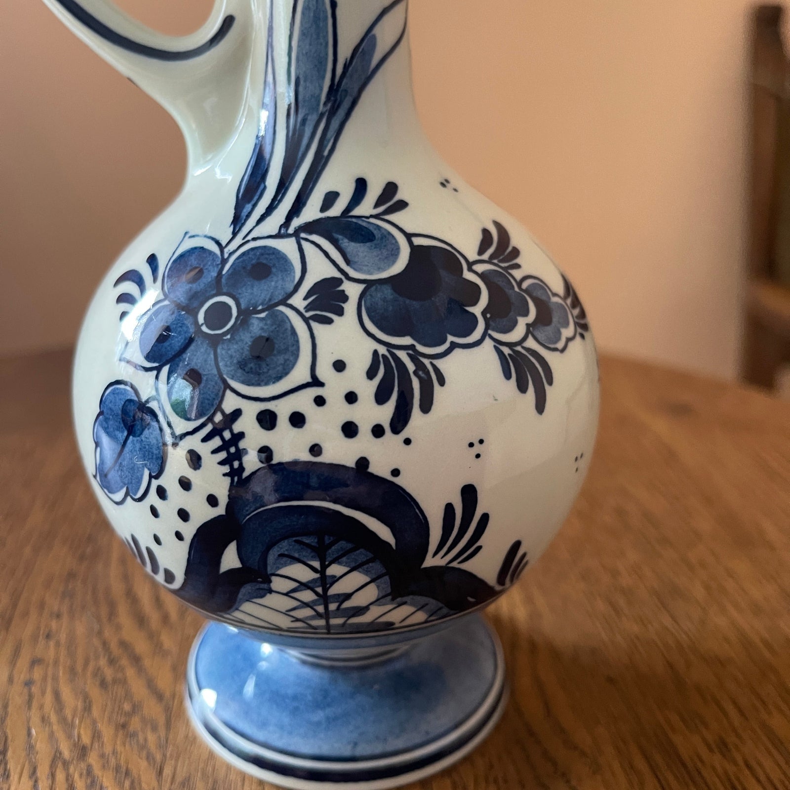 Ceramic vase with blue floral patterns on a wooden surface