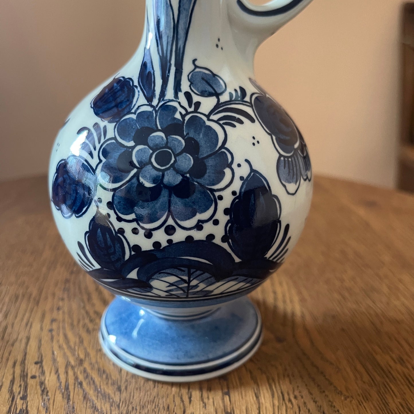 Blue and white floral-patterned ceramic vase on a wooden surface