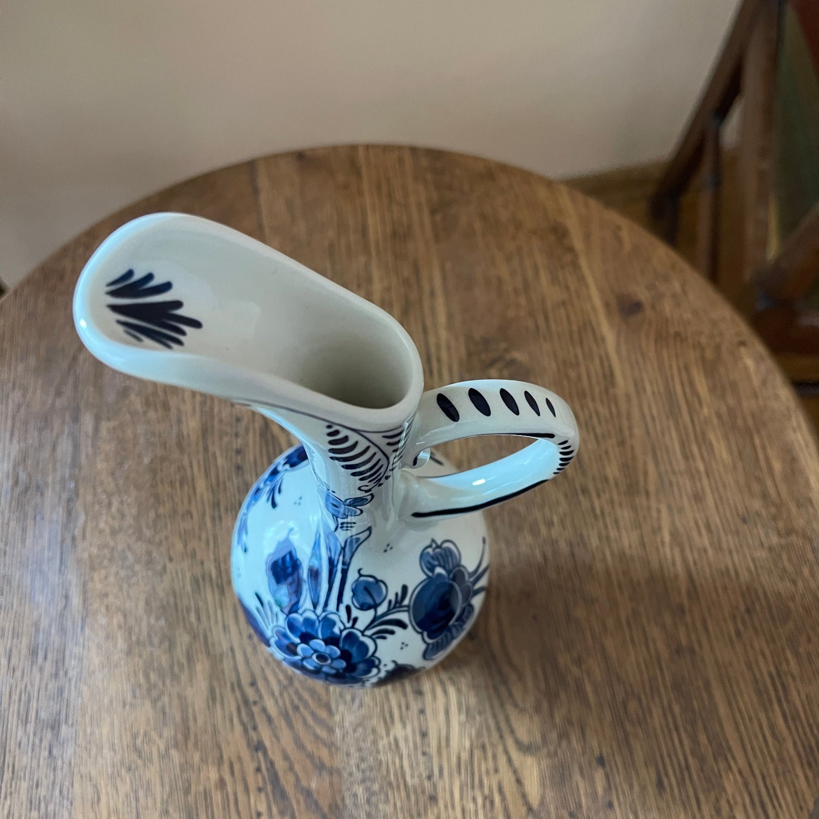 Ceramic vase with blue floral patterns on a wooden surface