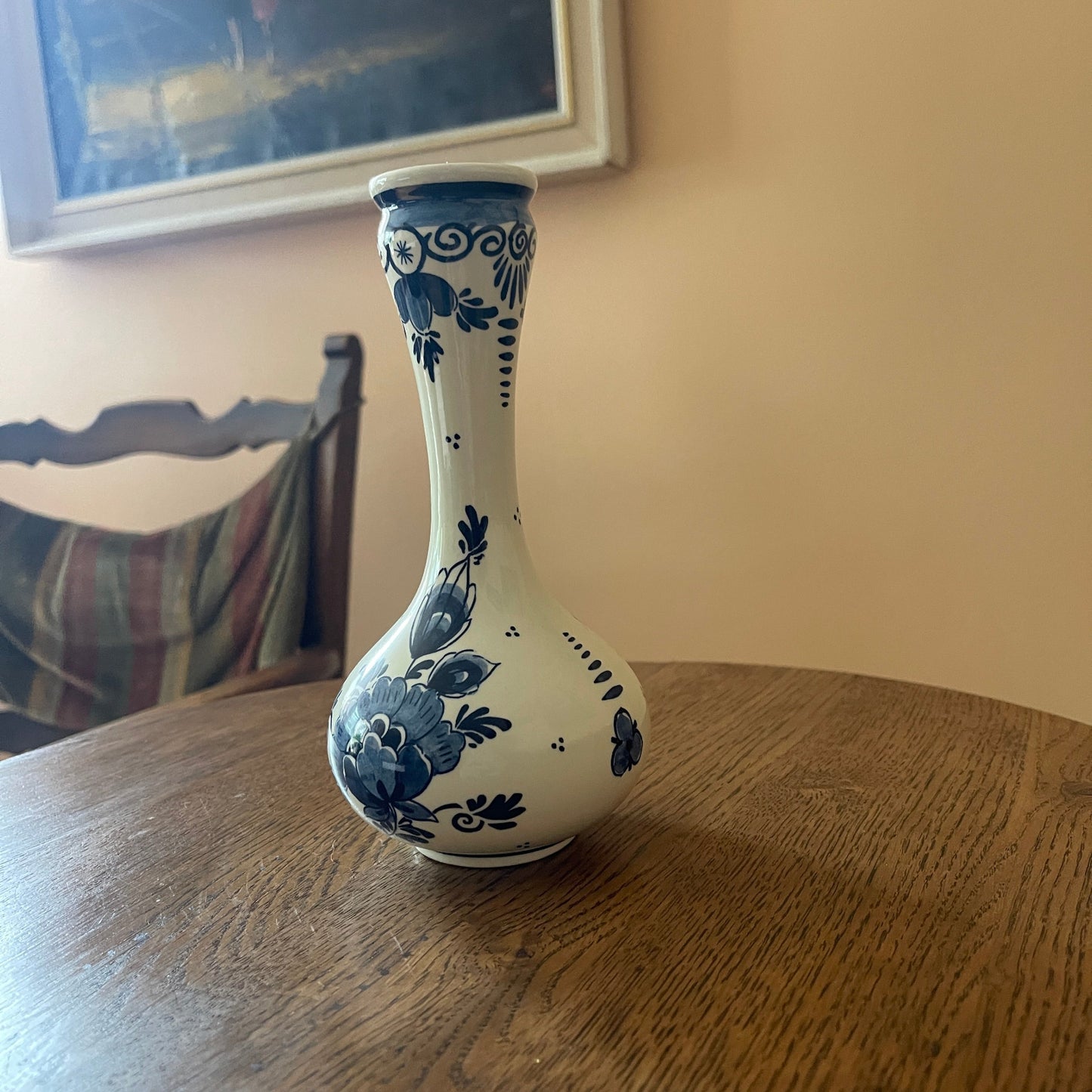 White vase with blue floral patterns on a wooden table