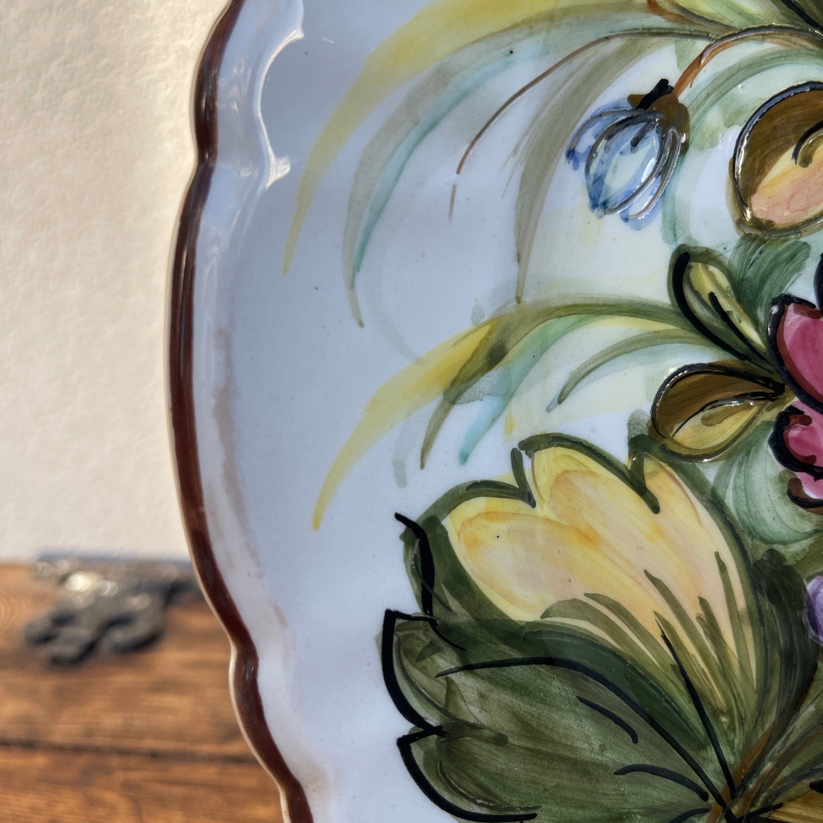 Decorative plate with floral patterns on a wooden surface