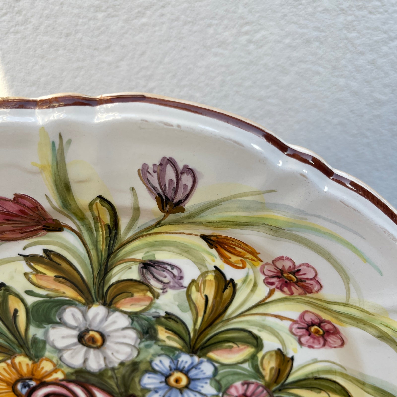 Decorative ceramic plate with floral patterns on a white background