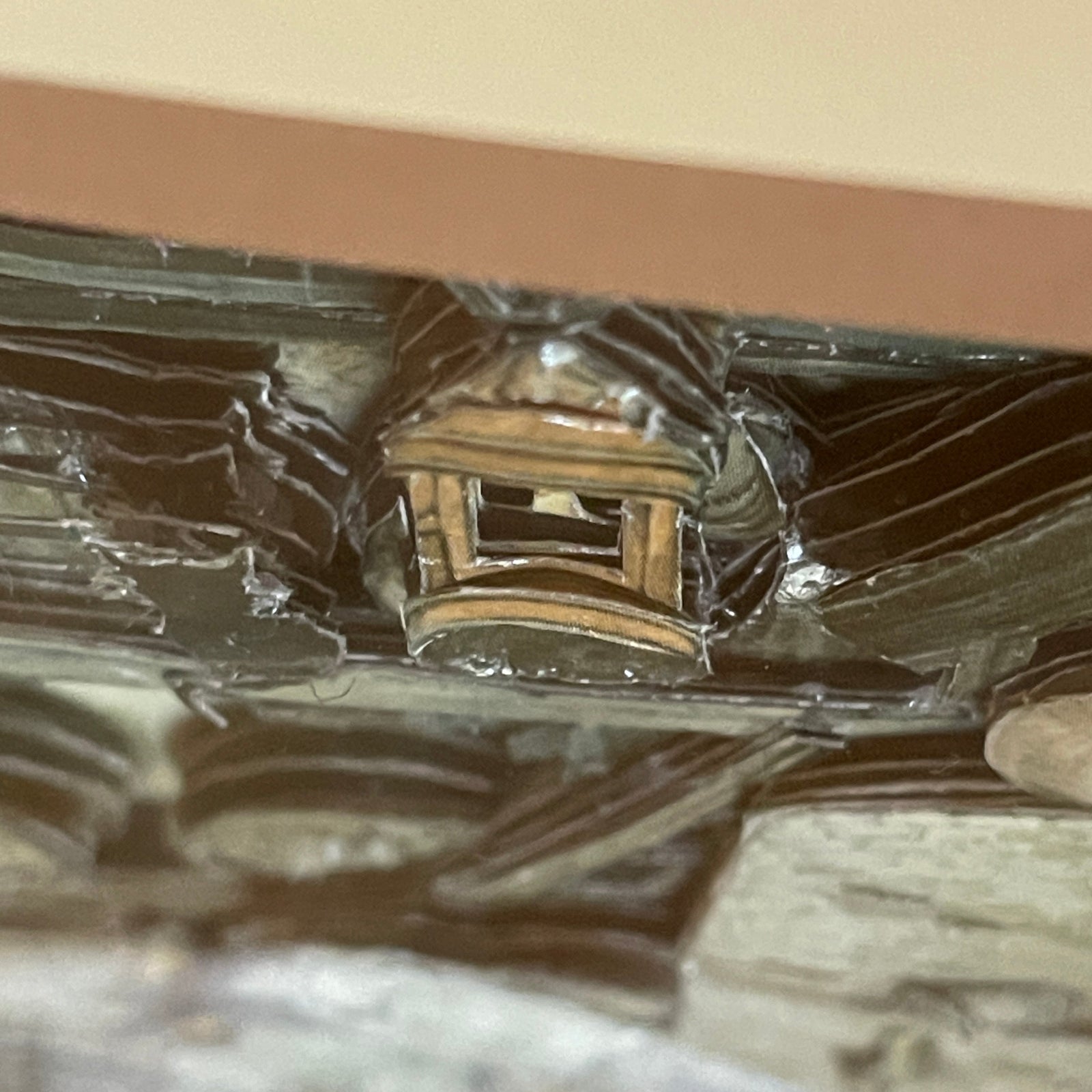 Close-up of a ceiling with a light fixture and reflective surface