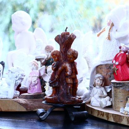 Decorative candle of a pair of children by the tree