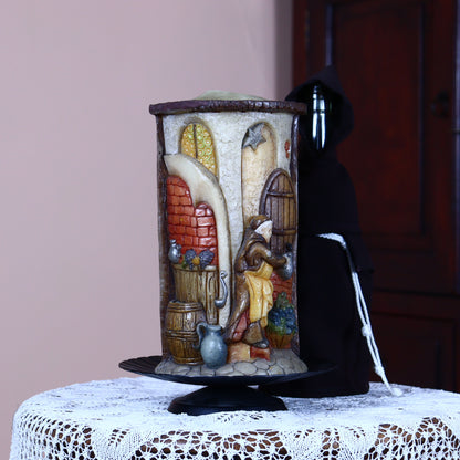 Old hand-made candle decorated with funny figures of monks